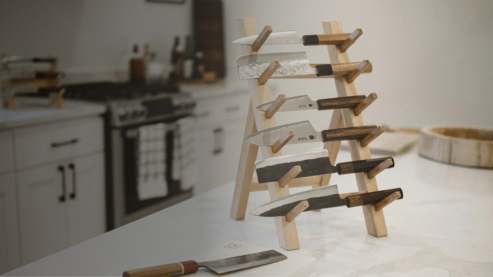 Set of knives on a wooden stand in a kitchen setting