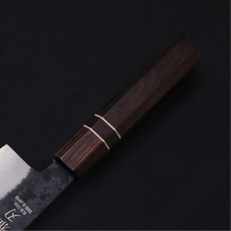 Close-up of Japanese knife’s durable non-slip ebony wood handle.